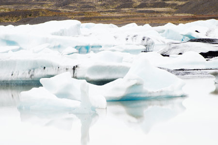 Glacier edge and water with reflections. Jokursarlon glacier, Iceland