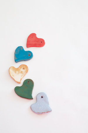 Love and diversity. Multicolored heart shaped ceramic pieces. White backgroundの写真素材