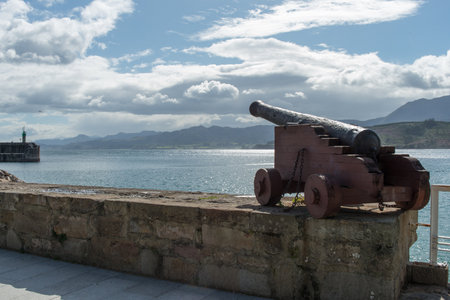 View of Cantabrian coast from Lastres harbor, with ancient cannon.の写真素材