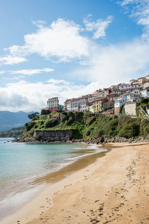 Beautiful view of Lastres from the beach. No people, sunny day. Lastres is a beautiful fishermen village,の写真素材