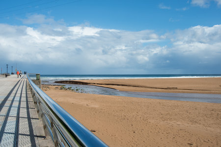 Beautiful view of La Griega beach and promenade. Autumn sunny day, no people. Colunga, Asturias, Spainの写真素材