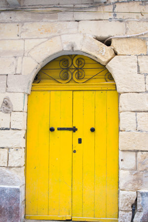 Traditional door, vibrant yellow. Malta, Europeの写真素材