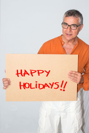 Middle aged man wishing happy holidays. White background.の写真素材