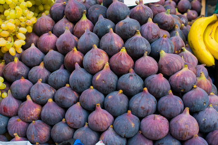 Fresh purple figs in a market stall. Figs are delicious seasonal fruitsの写真素材