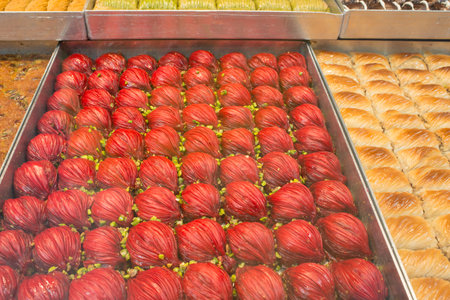 Close up of red turkish sweets. Istanbul. Many confectionerys can be found in Turkey with baklava and assorted productsの写真素材