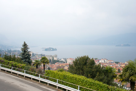 Beautiful aerial view of Lake Maggiore among the mountains, Italy. Islands of Isola Bella and Isola dei Pescatori. Cloudy day.The islands owes its fame to the Borromeo family who built a magnificent palace with a beautiful garden.の写真素材