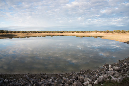 Beautiful landscape with lake and clouds. Clouds reflected in a lake on a sunny dayの写真素材