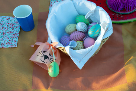 Flat lay of tablecloth and easter decoration as painted eggs and bunny bag