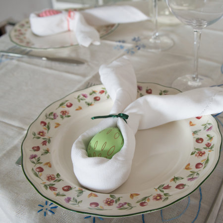 Table set with easter pattern. Napkin and decorated egg as a rabbit.
