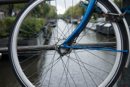 Bicycle parked on a bridge in Amsterdam. Channel in the backgroundの写真素材