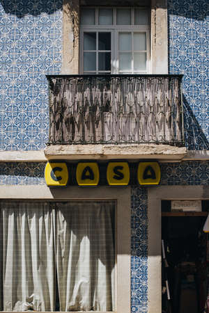 Tavira, Portugal; August 10, 2020: Sign in black letters on a yellow background on the facade of a...
