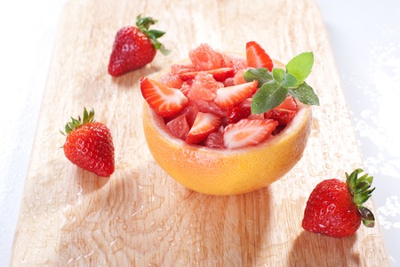 Fruit salad in hollowed-out grapefruit stuffed with strawberryの写真素材