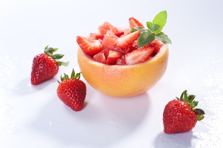 Fruit salad in hollowed-out grapefruit stuffed with strawberryの写真素材