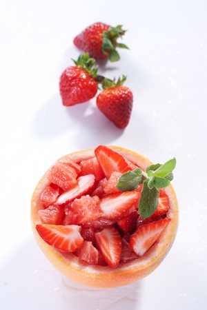 Fruit salad in hollowed-out grapefruit stuffed with strawberryの写真素材
