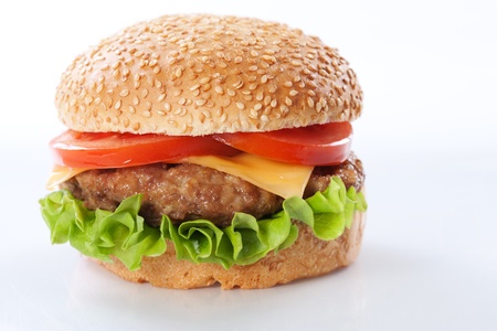 Cheeseburger with tomatoes and lettuce isolated on whiteの写真素材