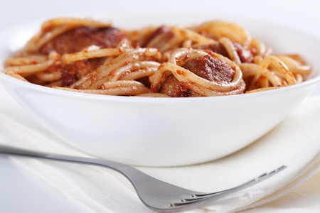 Pasta with meatballs and tomato sauce on white background の写真素材