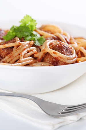 Pasta with meatballs and tomato sauce on white background の写真素材