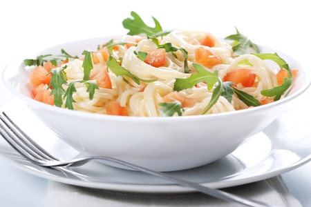 Pasta with tomato and rucola in bowlの写真素材