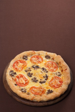 Fresh baked pizza with mushroom and tomatoesの写真素材