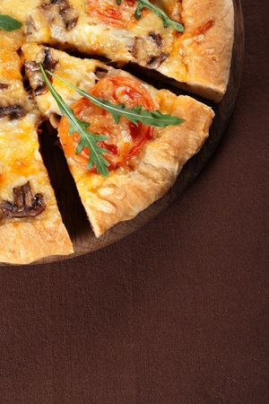 Fresh baked pizza with mushroom, tomatoes and rucolaの写真素材
