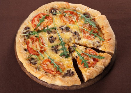 Fresh baked pizza with mushroom, tomatoes and rucolaの写真素材