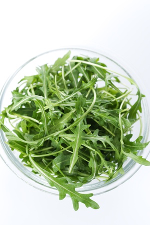 Green rucola fresh salad in glass bowl の写真素材