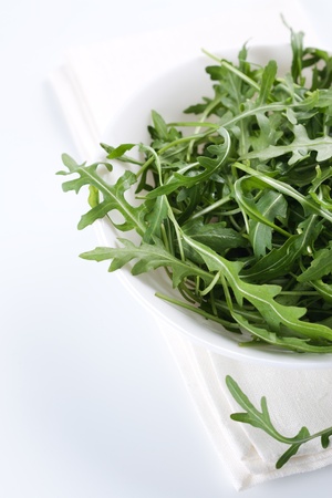 Green rucola fresh salad in white bowl の写真素材