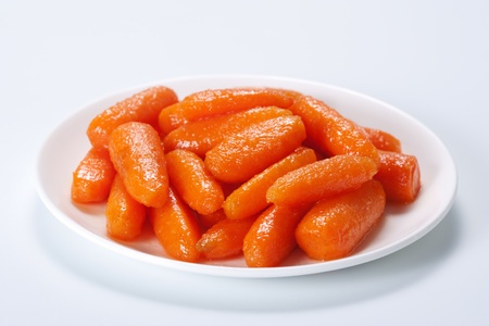 Honey glazed baby carrots in plateの写真素材