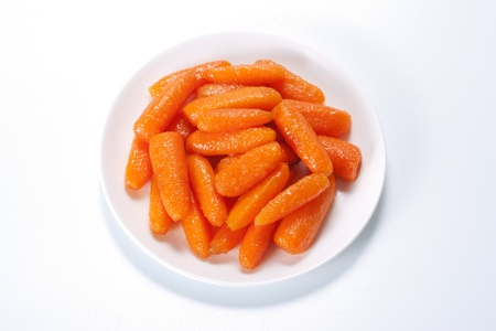 Honey glazed baby carrots in plateの写真素材
