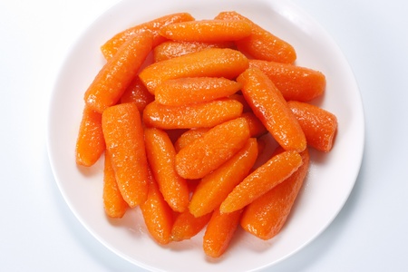 Honey glazed baby carrots in plateの写真素材