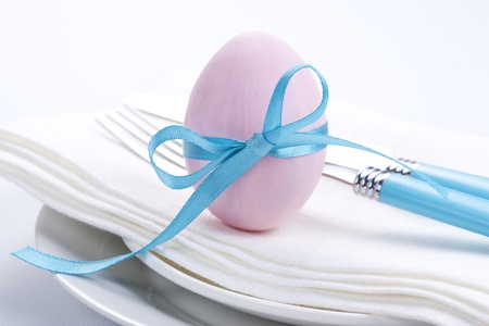 Easter table setting with plates, napkin, silverware and easter eggの写真素材