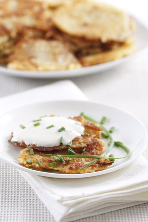 Potato pancakes on plate with sour cream の写真素材