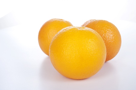 Three ripe oranges on white backgroundの写真素材