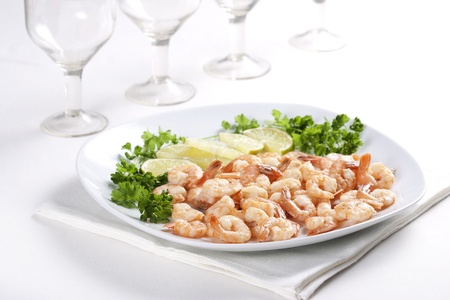 Shrimps on a plate with lime and parsleyの写真素材