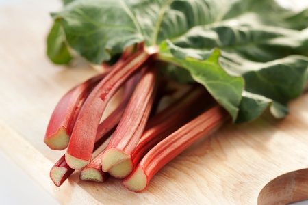 Bunch of fresh organic rhubarb on wooden background の写真素材