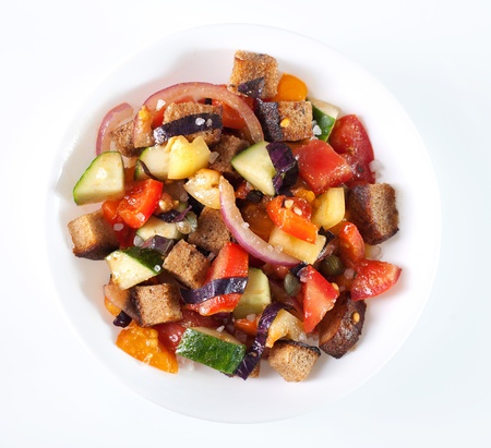 Italian panzanella bread salad in white bowlの写真素材