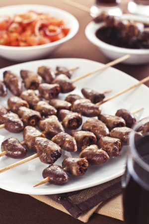 Grilled chicken hearts on skewers with soy sauce and salad.の写真素材