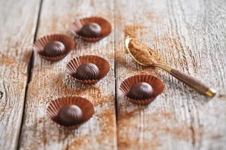 Chocolate candies on wooden background