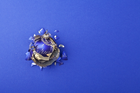 Broken christmas ball on blue backgroundの写真素材