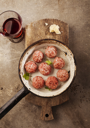 Meatballs cooking with mince, parsley, parmesan, wine and eggs の写真素材