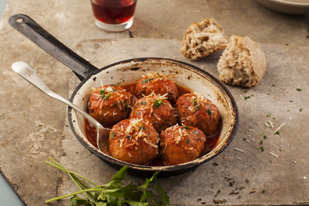 Meatballs cooked in tomato sauce in pan on grey backroundの写真素材