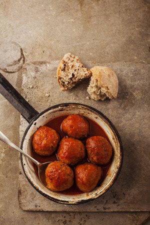 Meatballs cooked in tomato sauce in pan on grey backroundの写真素材