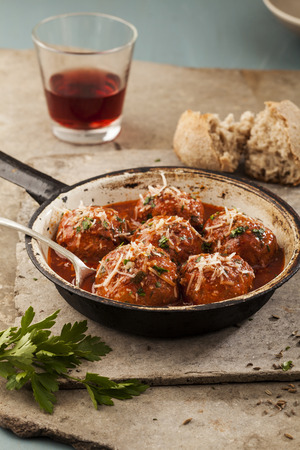 Meatballs cooked in tomato sauce in pan on grey backroundの写真素材