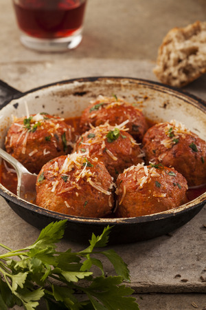 Meatballs cooked in tomato sauce in pan on grey backroundの写真素材