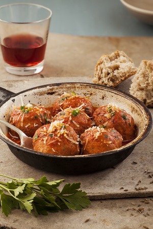 Meatballs cooked in tomato sauce in pan on grey backroundの写真素材