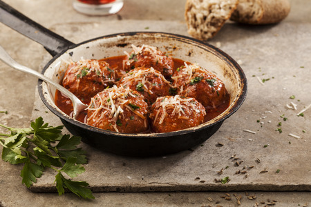 Meatballs cooked in tomato sauce in pan on grey backroundの写真素材