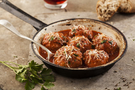 Meatballs cooked in tomato sauce in pan on grey backroundの写真素材