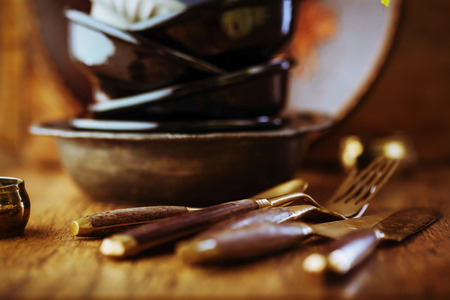 Vintage tableware, cutlery on dark brown wooden backroundの写真素材