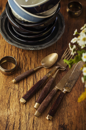 Vintage tableware, cutlery on dark brown wooden backroundの写真素材