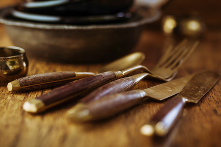 Vintage tableware, cutlery on dark brown wooden backroundの写真素材